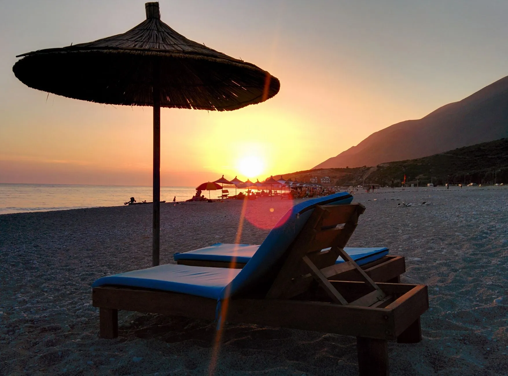 Espreguiçadeiras e chapéus-de-sol numa praia da Riviera Albanesa