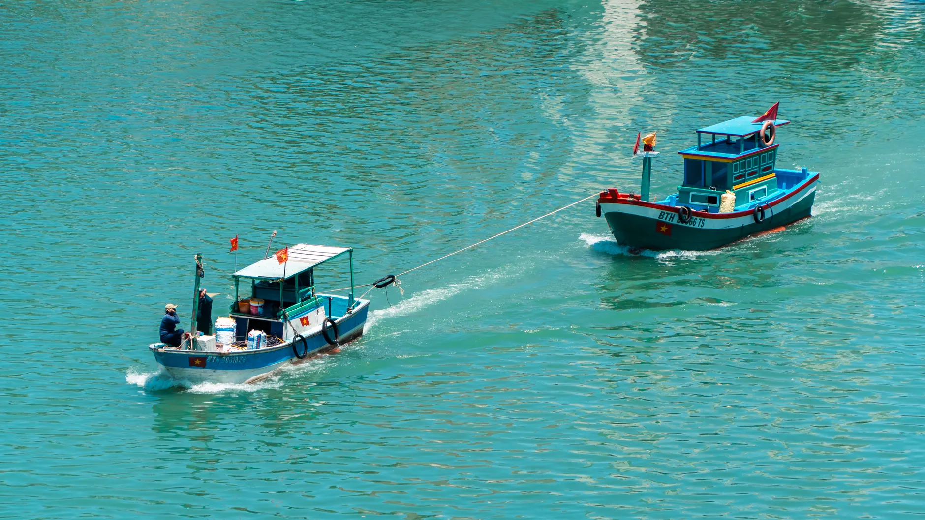 Barco de madeira em água turquesa na Riviera Albanesa